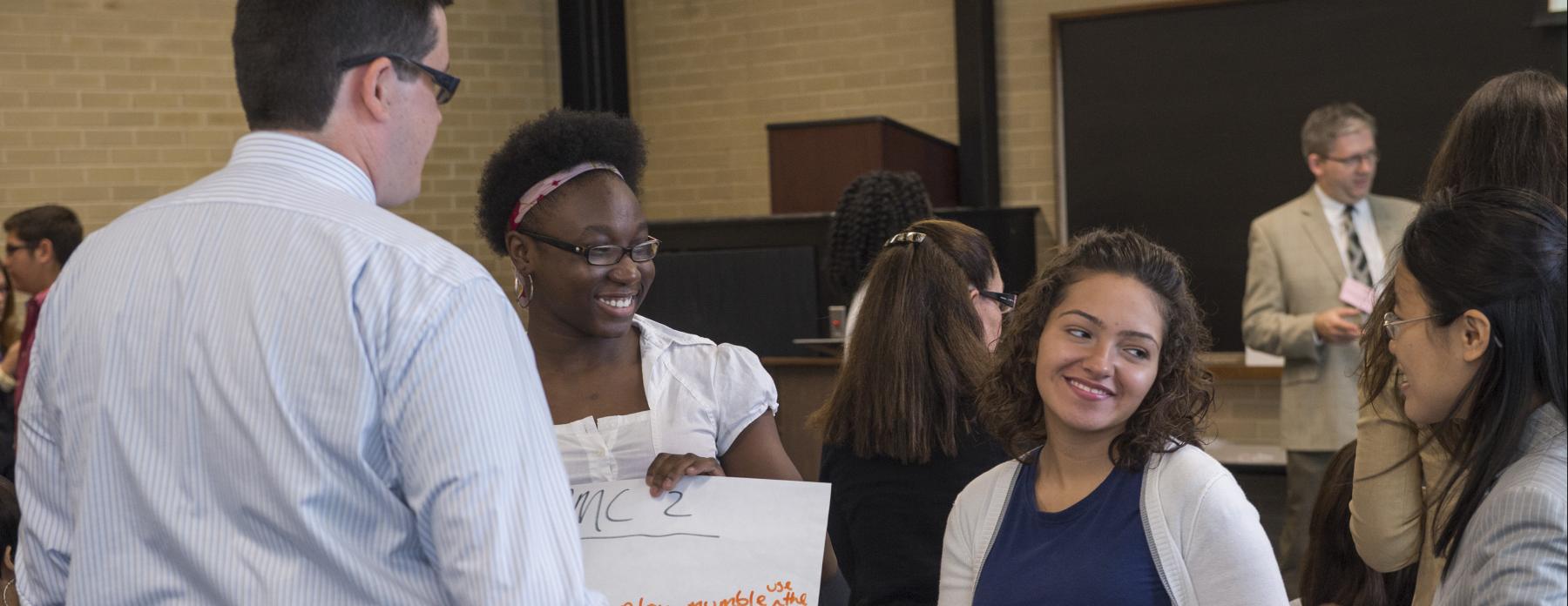 UTEP students talk to one another at an event